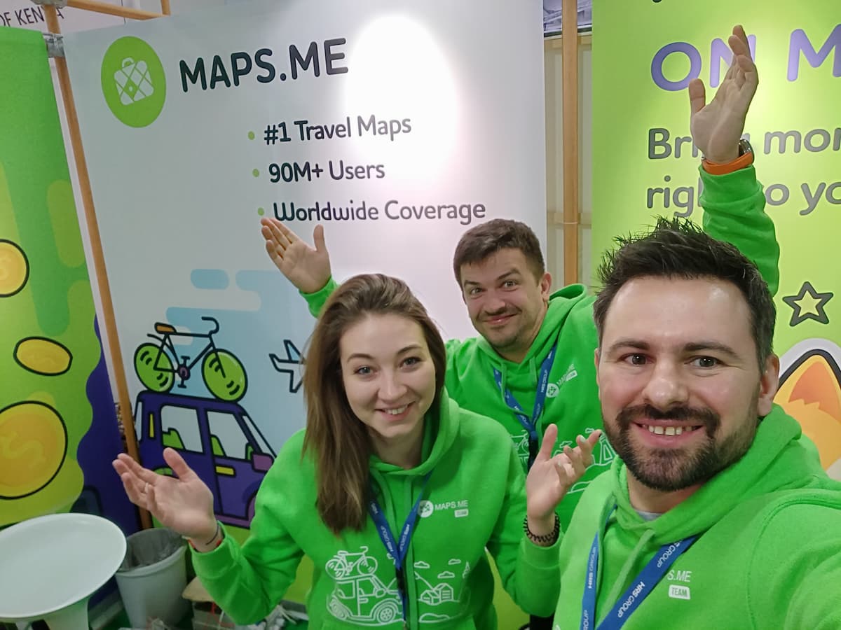 Eugene Lisovskiy with MAPS.ME team at conference booth, #1 Travel Maps app, 90M+ users, 2018